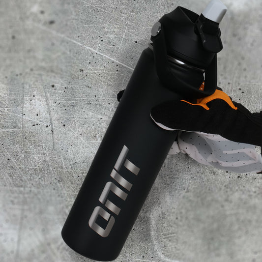 ONIT Black MTB water bottle, held in hand